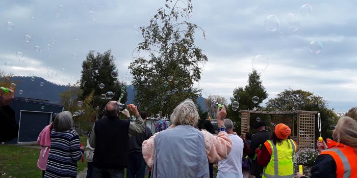 People blowing bubbles outside at Derwent Valley Community House